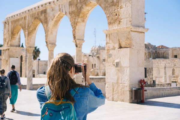 woman taking travel photos with camera woman taking travel photos with camera